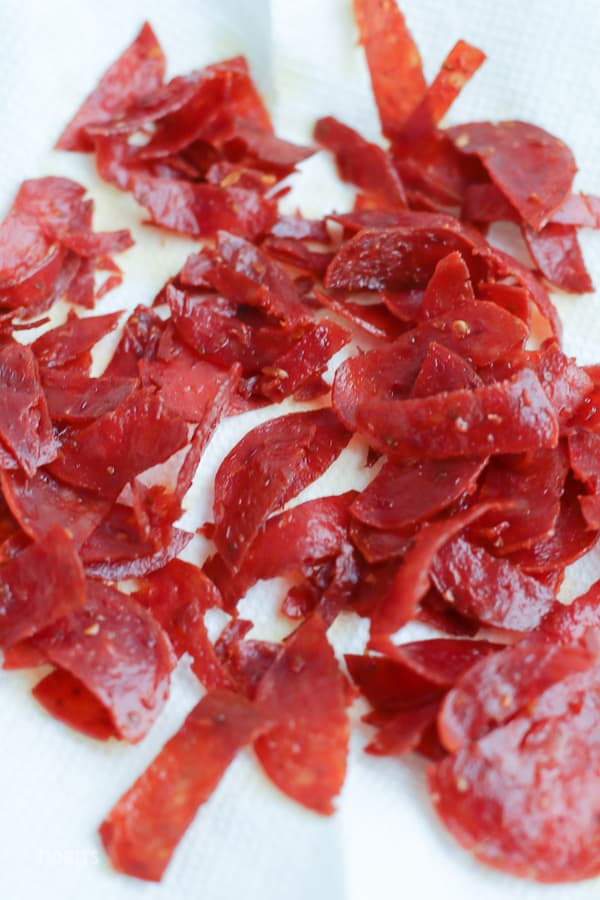 Diced pepperoni on a white background
