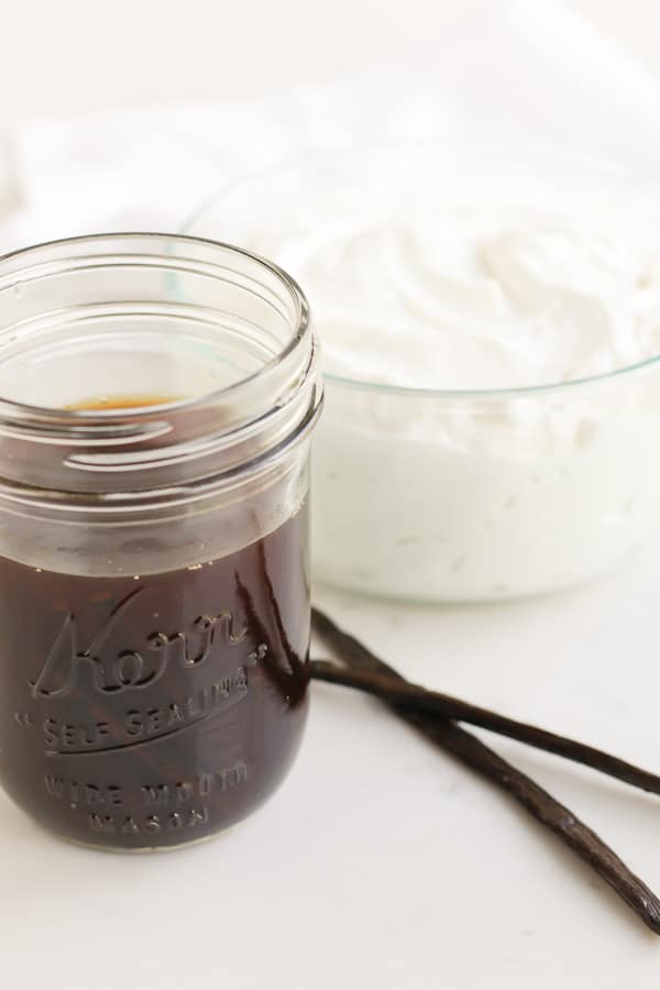 mason jar of vanilla extract and bowl of yogurt