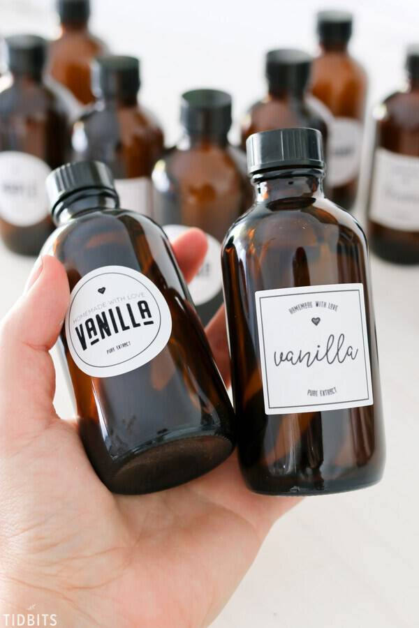 bottles of vanilla extract held in hands