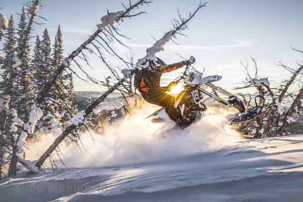 A motorbike rider jumping in snow