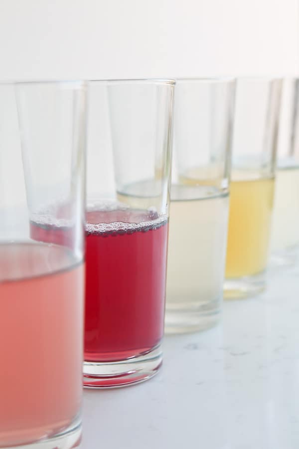 Tall glasses of infused water on a white background