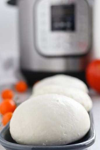 Balls of pressure cooker mozzarella with an Instant Pot in the background