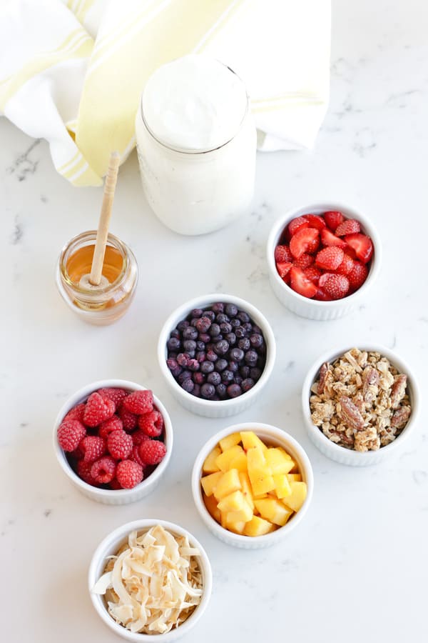 Instant Pot Yogurt Parfait next to fresh fruit toppings