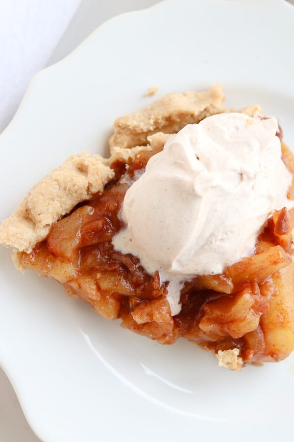 Caramel Apple Pie on a white plate with whipped cream