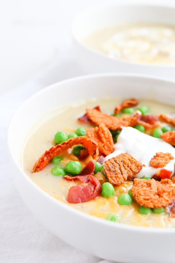 A bowl of baked potato soup with toppings