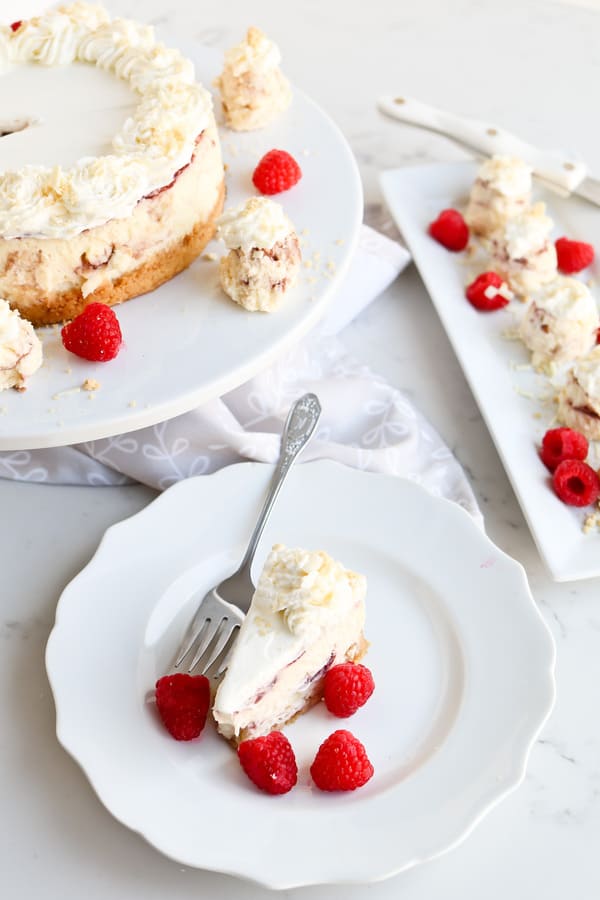 Pressure Cooker White Chocolate Raspberry Cheesecake with a slice served on a small plate