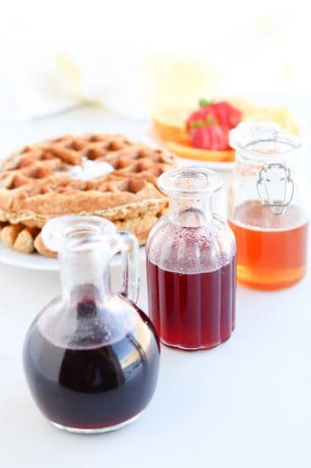 Pressure Cooker Infused Honey Syrup in jars next to a waffle