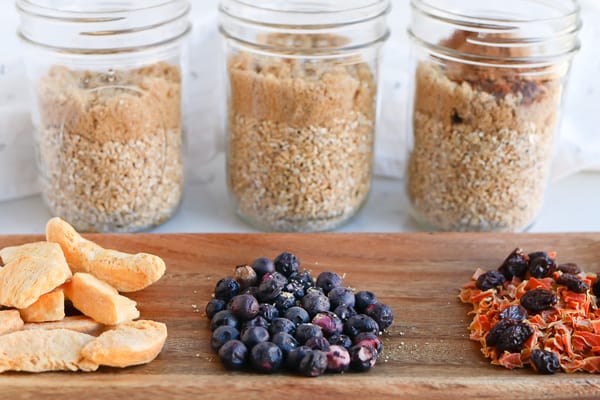 Fresh toppings in front of three jars of Pressure Cooker Steel Cut Oats