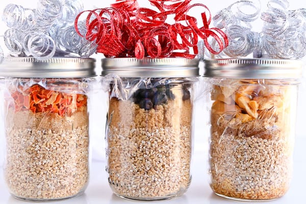 Three jars of Pressure Cooker Steel Cut Oats decorated with ribbon