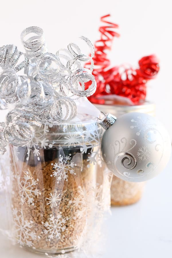 Pressure Cooker Steel Cut Oats in a jar, decorated with Christmas ribbons