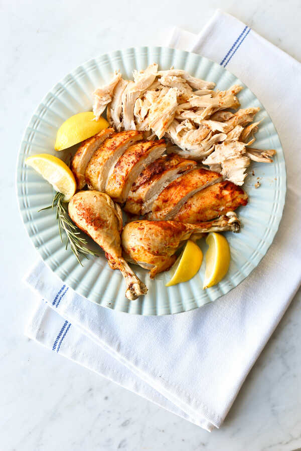 Roasted chicken on a blue serving plate