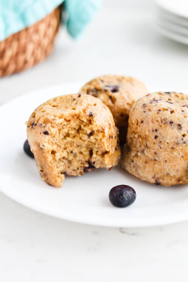 Close up of blueberry oatmeal muffins on a white plate