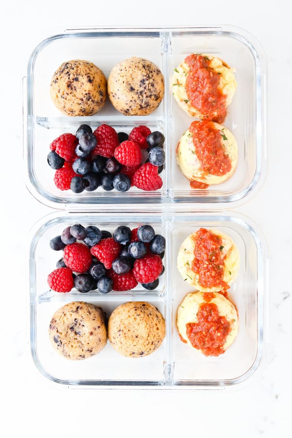 Top down shot of sous vide eggs and blueberry oatmeal muffins in a lunch box