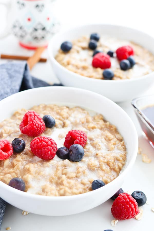 Two bowls of Pressure Cooker Maple Cinnamon Oatmeal topped with berries