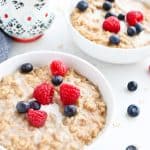 Two bowls of maple cinnamon oatmeal on a breakfast table