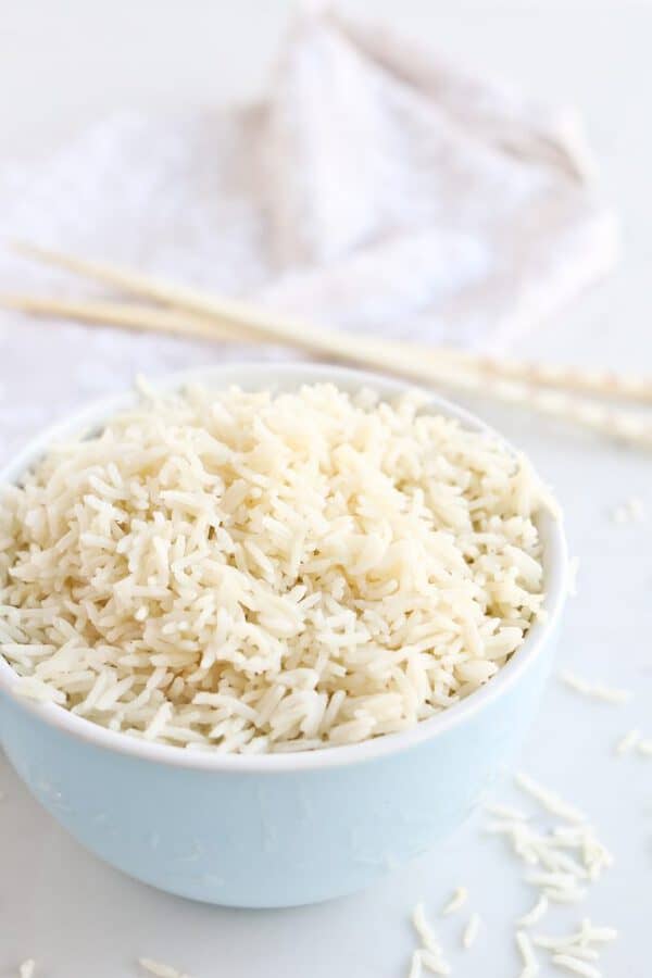 White Rice in a bowl with chopsticks