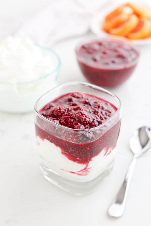 Instant Pot Triple Berry Chia Jam in a glass bowl over yogurt