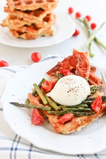 Instant Pot Poached Egg and Hashbrown Stacker on a plate with asparagus and tomatoes