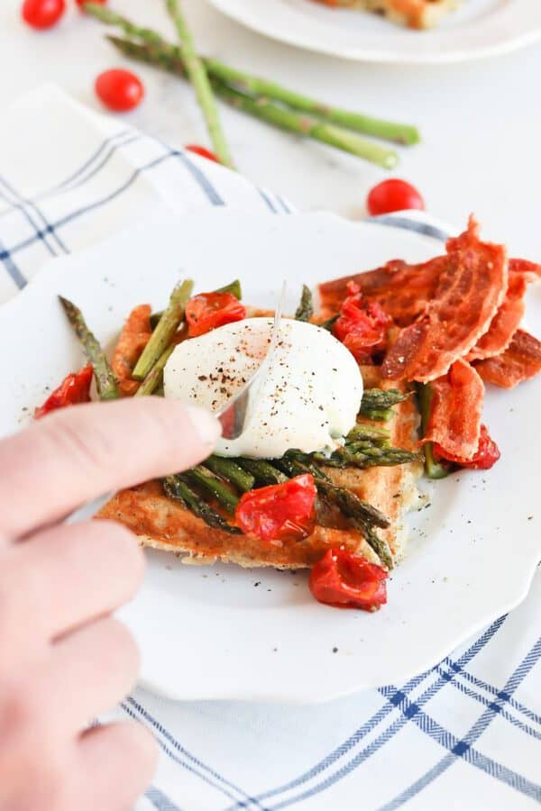 Instant Pot Poached Egg and Hashbrown Stacker on a plate with asparagus and tomatoes 
