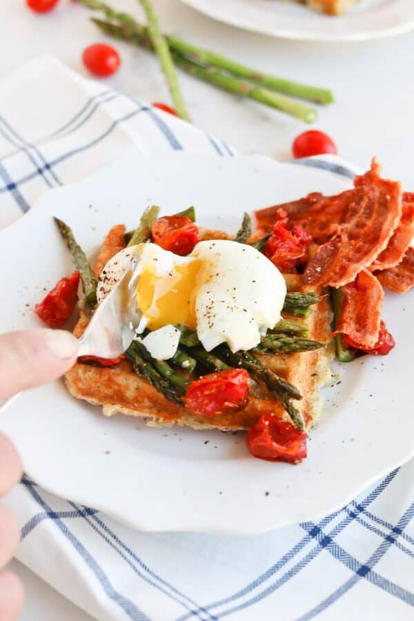 Instant Pot Poached Egg and Hashbrown Stacker on a plate with asparagus and tomatoes 