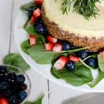 Top down shot of a blue cheese cheesecake dressed with fresh fruit