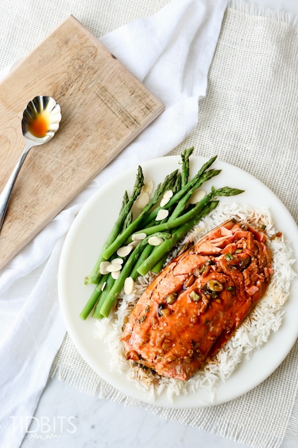 Top shot of Teriyaki Salmon on a white plate served with greens