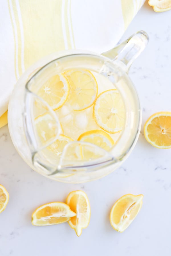 Instant Pot Lemonade in a pitcher with ice and lemon slices