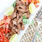 Instant Pot Steak Fajitas on a plate with peppers and onions