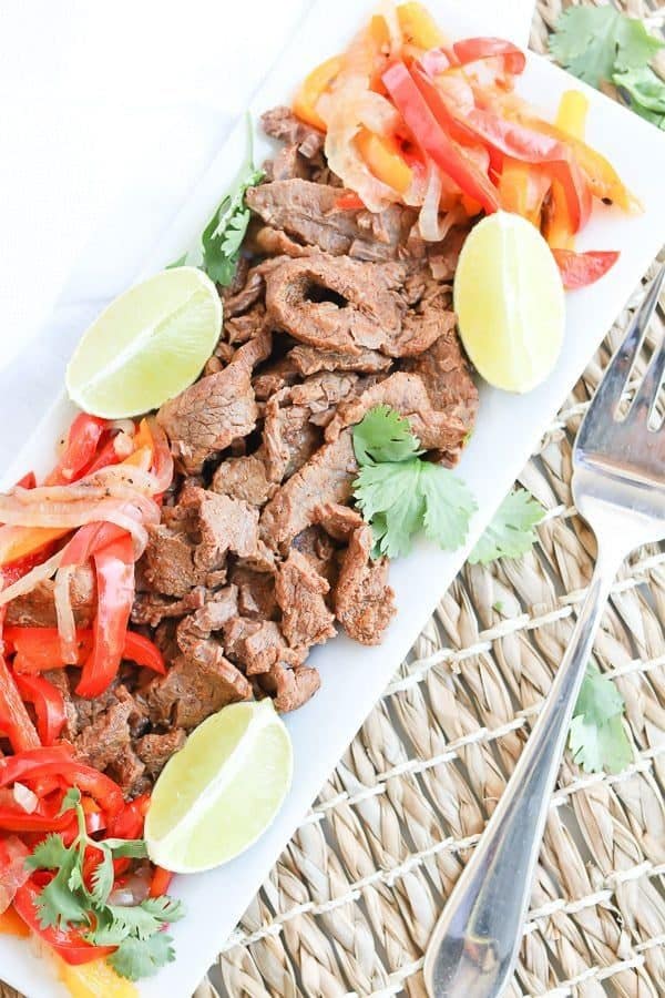 Instant Pot Steak Fajitas on a plate with peppers and onions