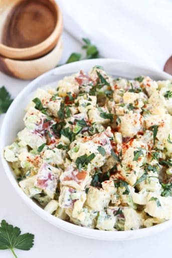 bowl of potato salad with chopped parsley