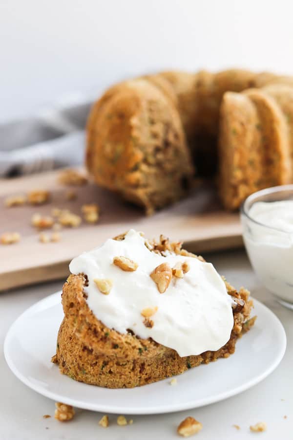 zucchini bread with yogurt sauce on a plate with a fork