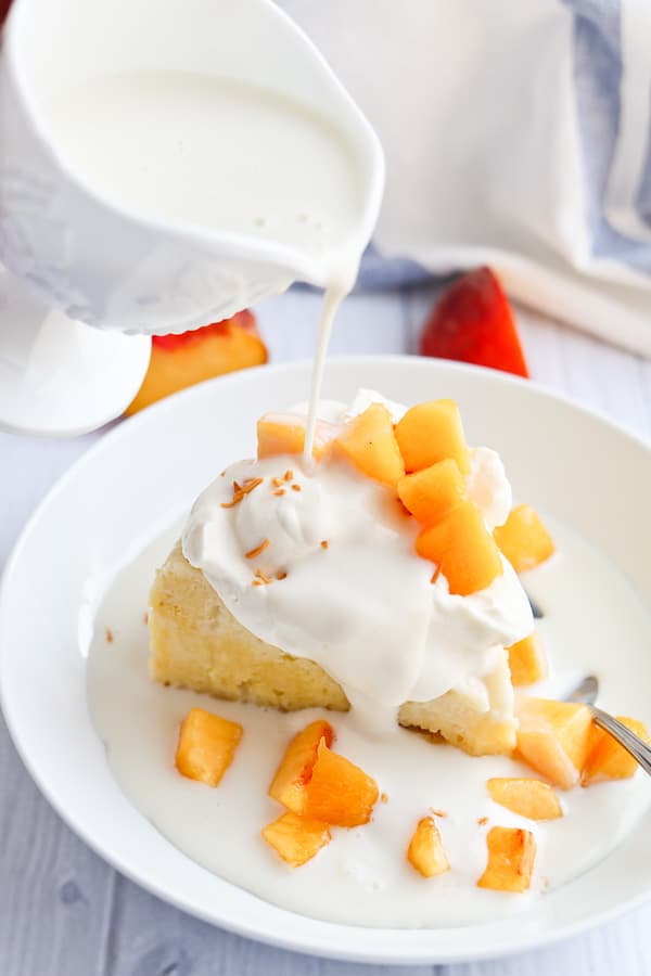 tres leches cake with peaches and cream and sweet milk drizzle