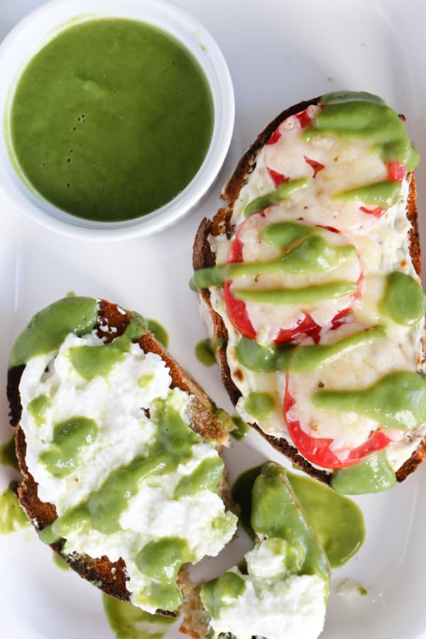 cheesy toast with green zucchini sauce over top