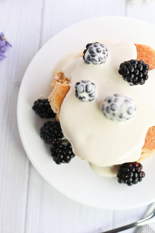 pancakes with cashew cream sauce and blackberries on a plate