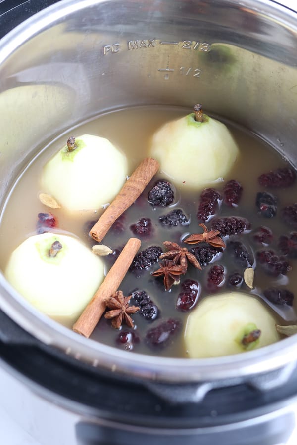 Pot of pears, poaching liquid, and spices