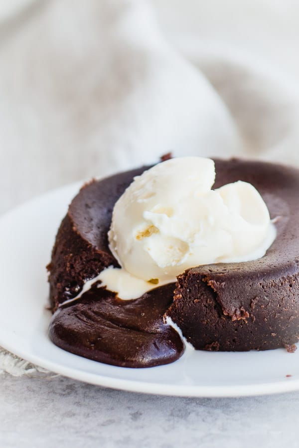 Chocolate lava cake on a white plate with ice cream