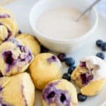 Blueberry breakast cakes on a white plate with creamy dip