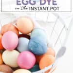 colored easter eggs in a white basket