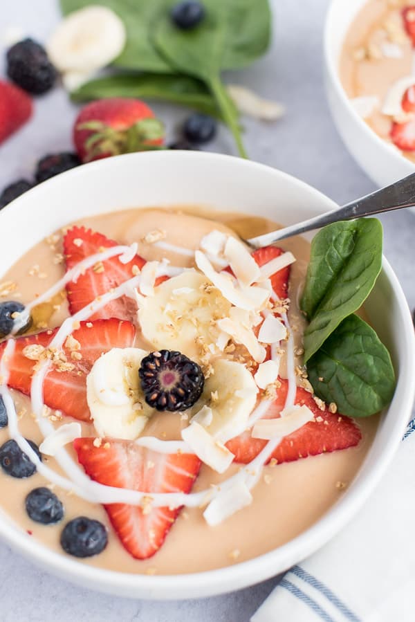 instant pot fruit soup in a bowl with fresh berries, coconut, and granola