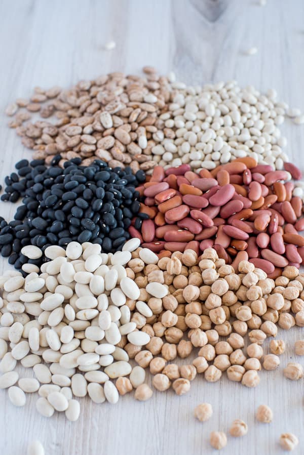 A variety of dried beans on a white surface