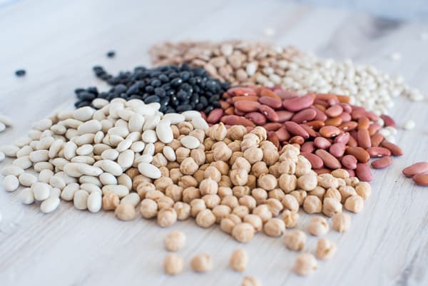 A variety of dried beans on a white surface