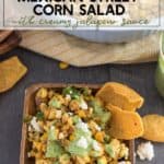 Mexican Street Corn Salad on a white plate with a side of corn chips