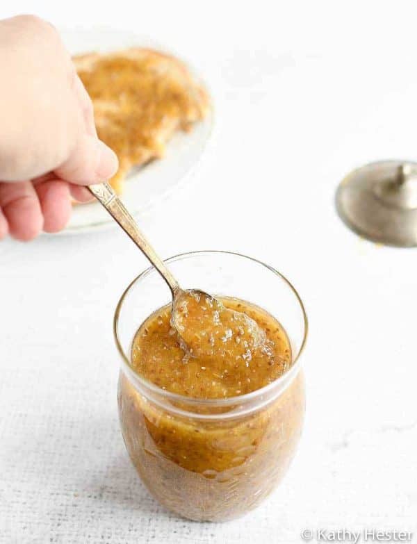 Peach chia jam in a jar with a spoon