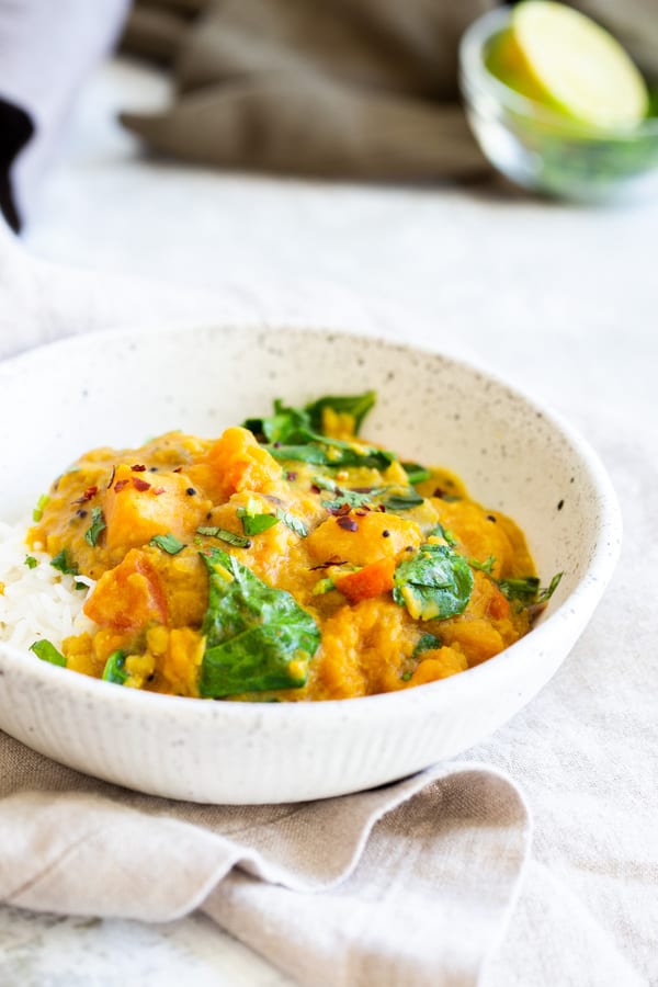Butternut Squash curry in a white bowl with rice