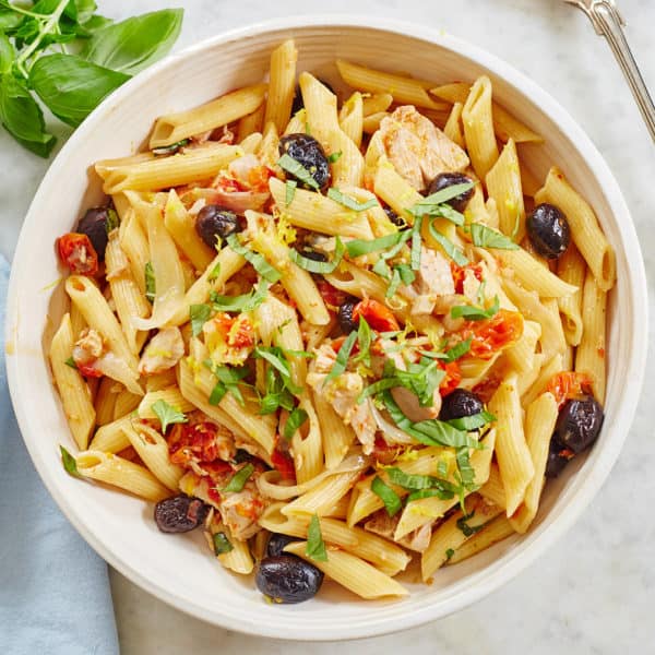 Bowl of pasta with tuna, tomatoes, and olives