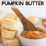 pumpkin butter in a white bowl with a spoon and biscuits on the side