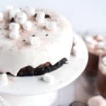 Hot chocolate cheesecake with marshmallow ganache sitting on a white dish