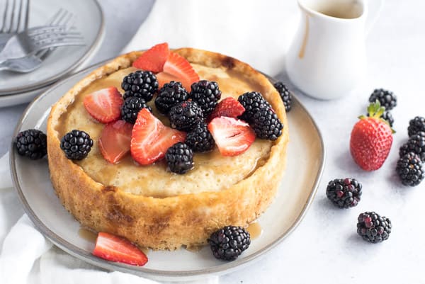 Giant pancake with berries and maple syrup