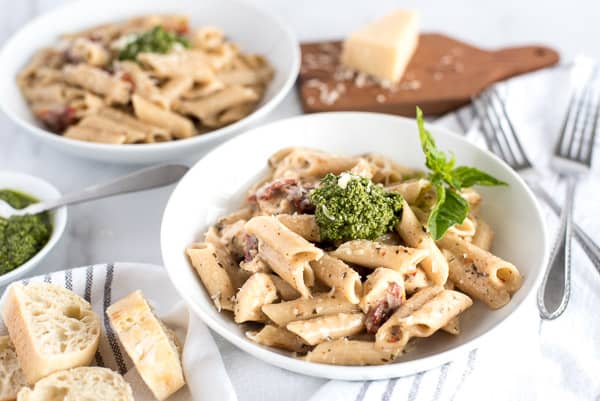 bowl of pasta with sun-dried tomatoes and pesto