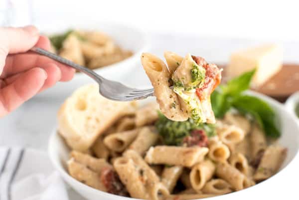 fork of pasta with sun-dried tomatoes and pesto